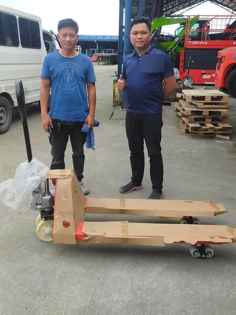 A customer and Vladimir with a newly delivered hand pallet truck