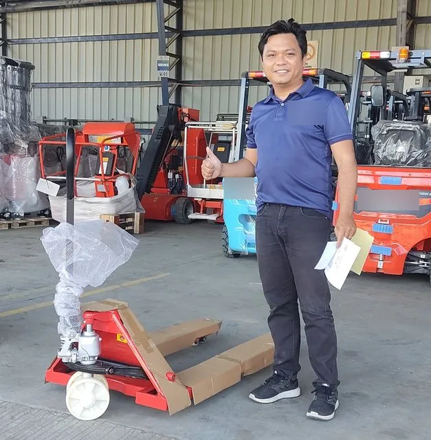 Vladimir beside a hand pallet truck ready for release