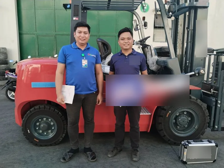 Vladimir and a customer holding the sold key beside a new forklift