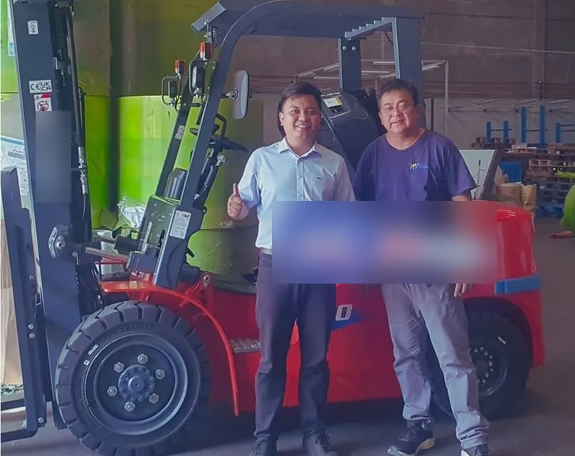 Vladimir and a customer with the sold key beside a forklift in a warehouse